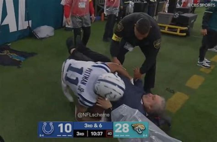 NFL sideline worker appears to break his LEG on live TV after horror collision with Saints running b